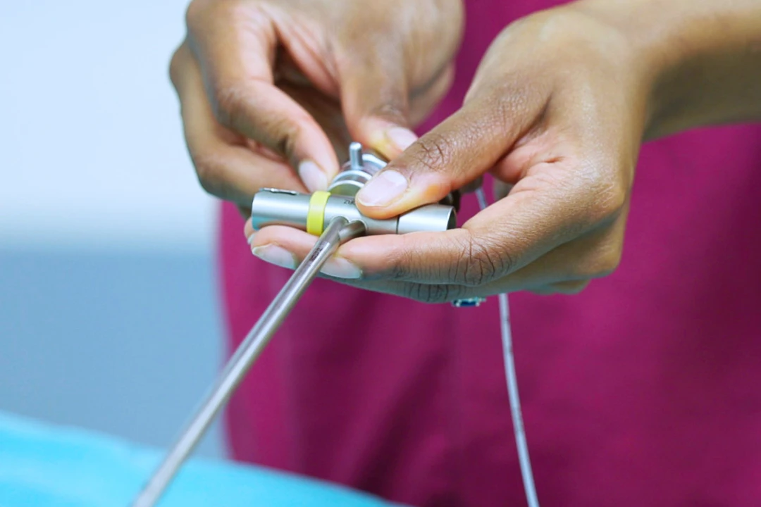 A clinicans holding part of a rigid bronchoscope.